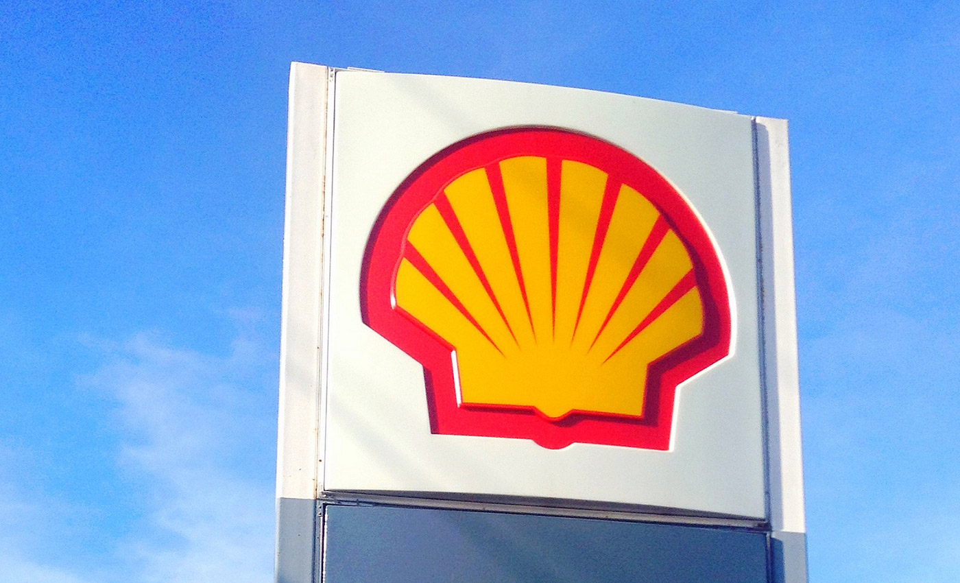 top of a sign displaying the shell logo
