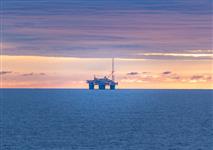 A distant image of a longboat Oil Rig